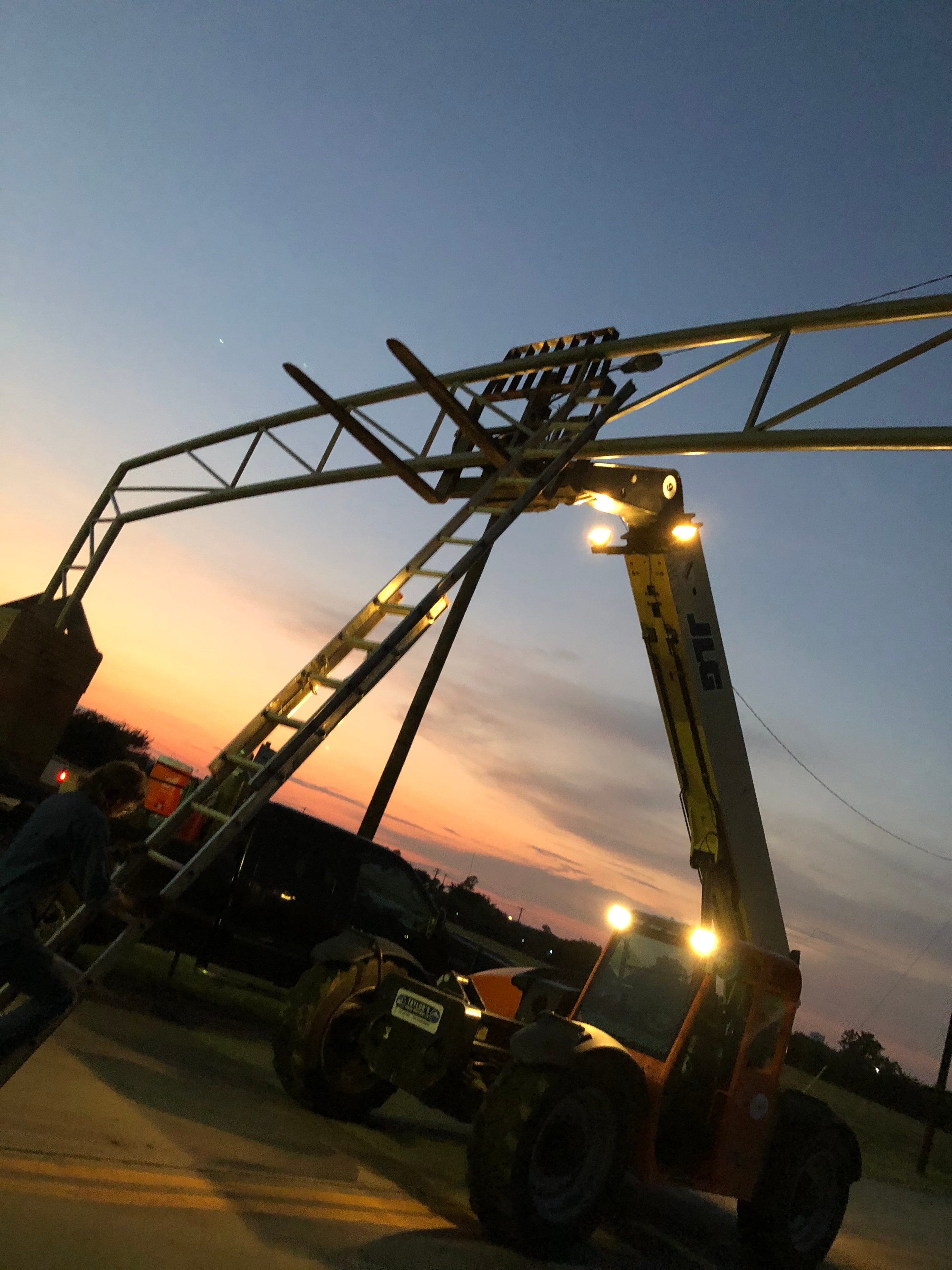 Construction crane illuminated at dusk