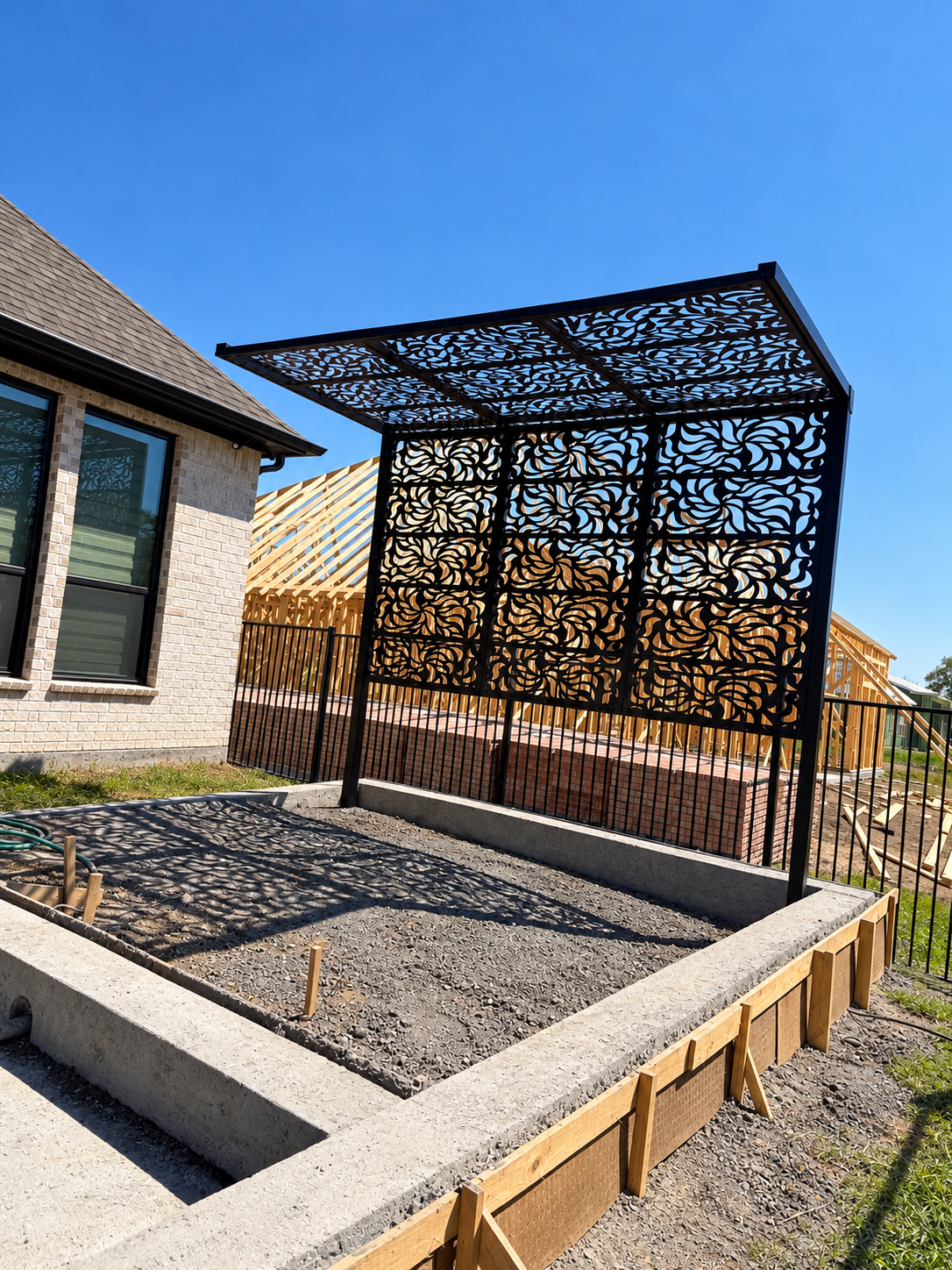 Custom black steel pergola with decorative panels